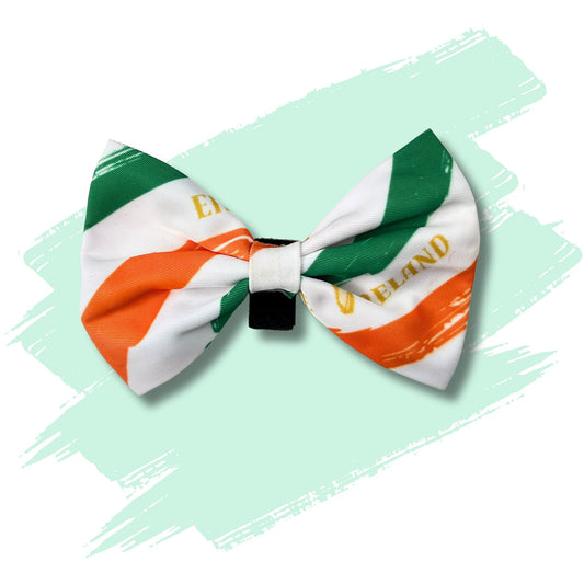 Dog bowtie featuring green white and orange stripes representing Irish flag and featuring the name Ireland Éire and the harp.