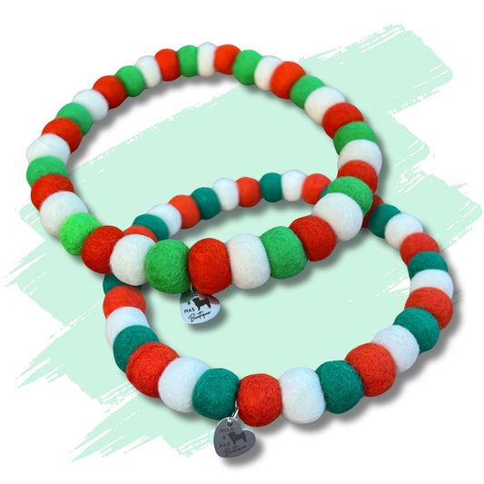 Dog pom pom necklace made of green white and orange wool felt balls representing Irish flag.